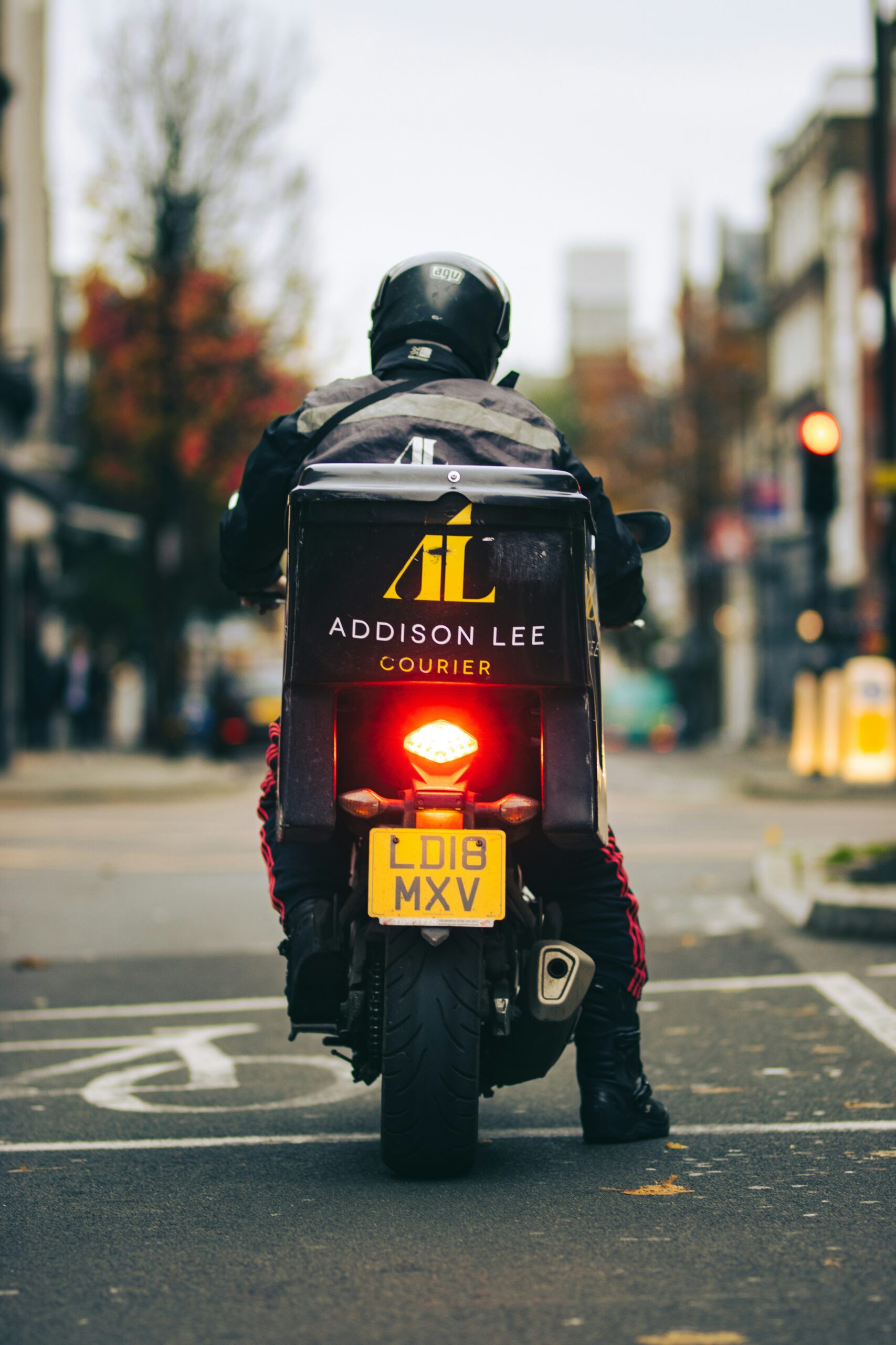 man in black helmet and black jacket with helmet on road during daytime